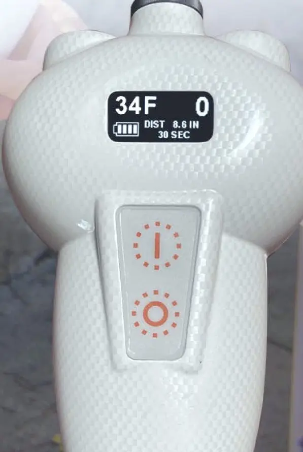 The white SubZero cryotherapy handpiece with its temperature display